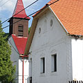 The St. Anne's Church of Háromhuta with its wooden steeple (tower), and an old welling house next to it - Háromhuta, ハンガリー